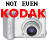 Pixelated image of a silver digital camera with purple lens, overlaid red 'KODAK' text and black 'NOT EVEN' above; right side shows partial text 'CAN CAPTURE OUR MOMENTS' on same camera.