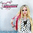 A pixelated image of a woman with long blonde hair and sunglasses, wearing a silver and black checkered top, with pink text on a black background reading "Don't judge a CD by it's cover... Judge it by it's songs!" and "AVRIL ROX!! <333".