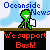 Pixelated green character with white eyes and a small smile stands on brown ground beneath blue sky, holding white object while text bubbles repeat 'Today's News: What makes a bad President?' and 'We support Bush!' in red.