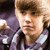 Pixelated image of a person with light brown hair wearing a purple jacket, overlaid with colored text phrases in different