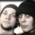 Two pixelated faces in close proximity, one with dark hair and the other with lighter hair against a light background.
