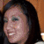 Four- of a woman with dark hair smiling in various poses, one with pink text overlay