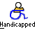 Pixelated static icon featuring a blue wheelchair symbol with yellow and black accents, positioned above the word "Handicapped" in blocky pixel font on a gray background.