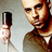 A pixelated image of a person holding a microphone with green text on black background.