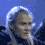 A person with long light-colored hair in a dark outfit against a blue background, shown across of an animation
