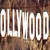 Pixelated brown background with white text reading 'OLYMPIC' in bold, blocky letters.