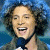 A 50x50 pixel animated contact sheet showing two frames of a person singing into a microphone on the left and green text reading "Original Icons .com" on the right against a dark background.