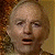 A 50x50 pixel buddy icon split into two frames showing a character's face on the left and green text on a dark background on the right, with visible pixelation and dithering effects.