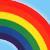 A pixelated rainbow arc spans diagonally across a light blue background, displaying red-orange-yellow-green-blue-purple bands with visible color blending.