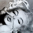 Pixelated grayscale image of a stylized character with large eyes and a wide mouth, wearing a hat-like shape on the head.