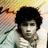A pixelated image shows a person with dark curly hair lying on a patterned surface, next to red text reading "All i want 4 Christmas is." and "HIGK JONOS! -Giera.Grace LW.Amanda".