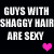 Pixelated text reads 'GUYS WITH SHAGGY HAIR ARE SEXY' in two with pink hearts below, displayed on a black background
