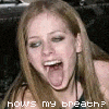A woman with light brown hair and blue eyes sticks her tongue out, mouth open, with pixelated text below reading 'hows my breath?'