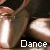 Pixelated close-up of a person's lower legs and feet in motion, with the word "Dance" displayed below.
