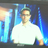 Pixelated static image of a person in a white shirt against a blue and gray background with light streaks.