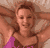Animated contact sheet showing three frames of a woman in a pink swimsuit lying on her back with hands behind head, smiling at the camera against a light-colored background.