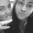 Two grayscale figures in close proximity, one with visible facial features and the other partially obscured by pixelation.
