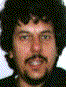 Four distinct human faces arranged in a , each with unique hair and facial features, displayed in a pixelated style