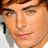 Pixelated portrait of a person with brown hair and light eyes on left, red text on purple background reading 'I <3 ZAC EFRON HE'S SOOO HOT' with exclamation marks.