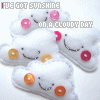 identical cloud-shaped icons with smiling faces, each holding a circular object, under text reading "I'VE GOT SUNSHINE ON A CLOUDY DAY" with color variations in the text