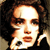 Pixelated close-up of a person with light skin tone, dark curly hair, and a black garment, holding a white object near the face.