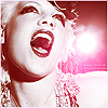 Pixelated close-up of a person with light hair shouting, mouth wide open, against a pink and white background with a bright light flare.