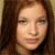 Two side-by-side pixelated frames of a person with long hair, showing subtle differences in facial expression and lighting between the left and right panels.