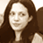 Static 48x48 pixel icon showing a person with long brown hair in sepia tones, cropped to head and shoulders against a light background.