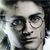 Pixelated grayscale image of a person's face with glasses, showing partial facial features and dark hair against a light background.