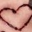 A static pixelated image of a heart shape outlined in dark brown against a light pink background.
