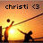 Pixelated image with orange-yellow gradient background showing two silhouetted figures against a bright sun, one figure holding a long object extending toward the other.