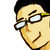 Pixelated close-up of a person's face with dark hair, glasses, and a slight smile against a white background.