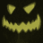 Yellow pixelated jack-o'-lantern face with triangular eyes and jagged mouth on dark background, displayed in a