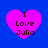 Four identical pink hearts on a blue background, each containing the text "I Love Julia" in black pixelated font.