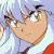 Pixelated close-up of a character's face with light brown skin, large green eyes, and dark eyebrows, wearing a white garment with red accents.