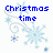 Pixelated blue text reads "Christmas time is here again" over light blue snowflakes and swirls on white background with gray rectangle.