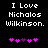 Black background with white pixelated text reading "I Love Nicholas Wilkinson." and five pink/purple pixelated hearts below.