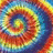 A vibrant, pixelated spiral pattern with swirling bands of red, yellow, blue, and green hues forming a continuous circular motion.