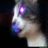 A cat's head in profile view with glowing eyes and mouth, transitioning through color changes against a dark background.