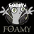 Pixelated cartoon character with green eyes and outstretched arms, displaying text above and below its head against a black background.