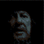 Six of a pixelated character with long hair and beard showing facial expression changes from neutral to smiling to grimacing against a dark background