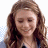 A pixelated image of a person with long brown hair and closed eyes, next to green text reading 'OriginalIcons.com' on a dark background.