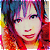 Pixelated static image of a stylized cartoon face with vibrant multicolored hair and red lips against a gradient background.