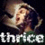 Pixelated image of a person with light hair and dark clothing, overlaid by white text reading 'thrice' on the left side.