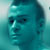 Pixelated static image of a person's face with teal color grading and visible dithering, displayed as a 50x50 buddy icon on a light background.