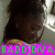 A child with dark hair in a high ponytail wears a striped shirt and looks down, with bright green text overlaid on the image.
