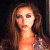 A pixelated image of a woman with long brown hair and dark eye makeup, next to green text reading 'Original Icons .com' on a solid background.