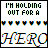 Pixelated text reads "I'M HOLDING OUT FOR A HERO" with heart symbols above and below, arranged in a of nine