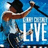 A person in a black cowboy hat and light blue shirt sings into a microphone against a blue background with 'LIVE' text.