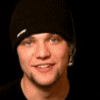 nine identical figures wearing black knit hats with white text, each showing a different facial expression against a solid black background